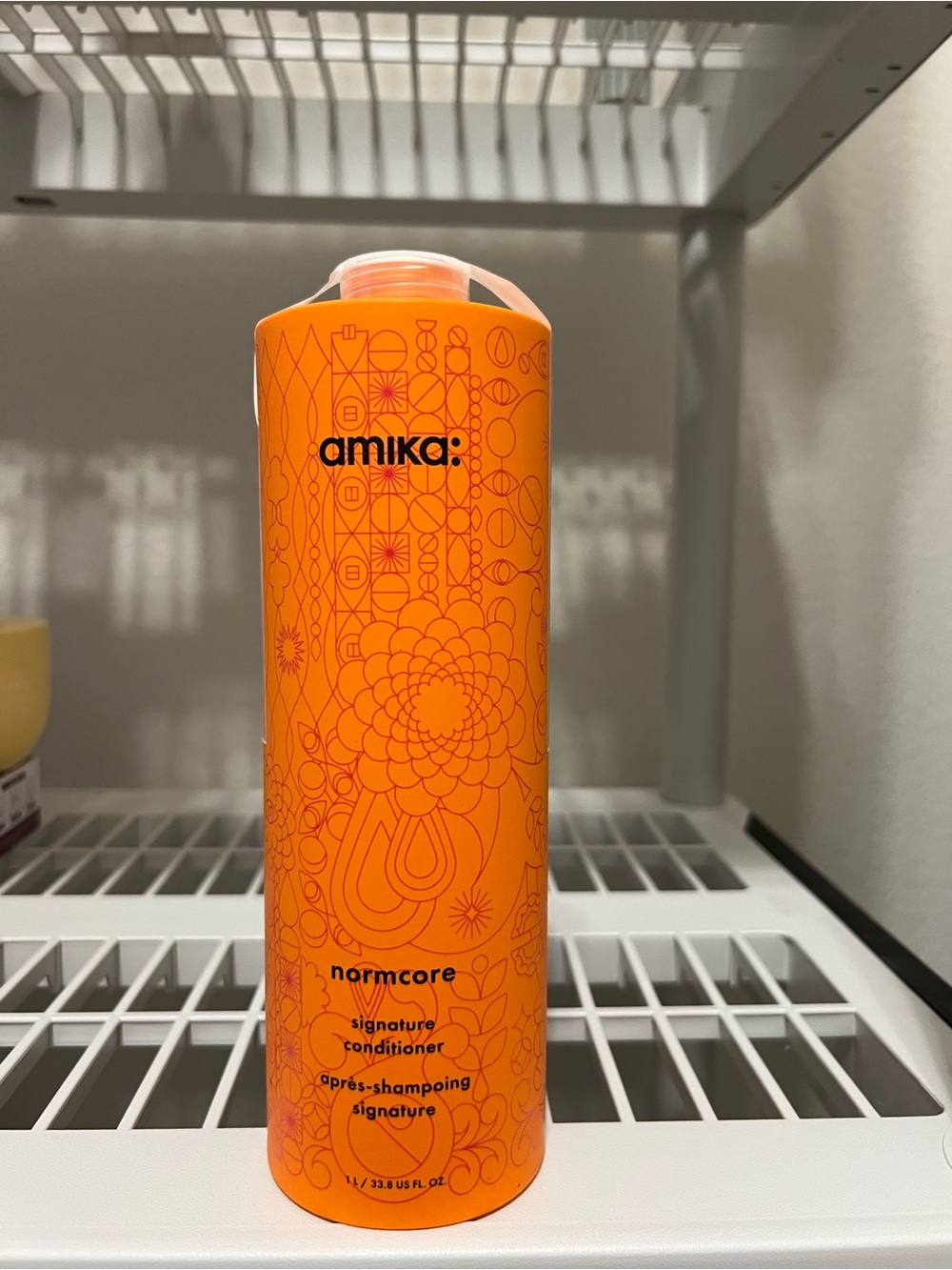 amika Normcore Signature Conditioner in Bright Orange Bottle
